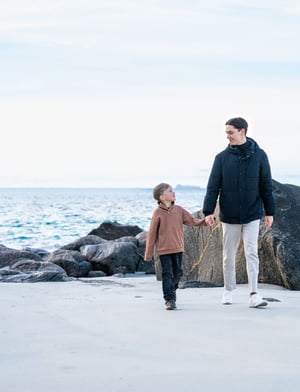 Man and boy walking on a beach_HAV Group_810x1060px