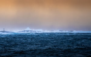 Orange sky and ocean with waves